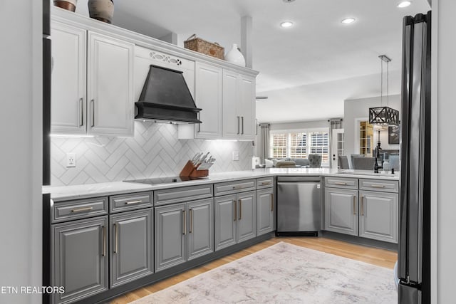 kitchen with premium range hood, gray cabinets, light wood finished floors, black electric cooktop, and dishwasher