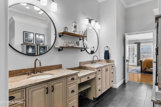 ensuite bathroom featuring double vanity, tile patterned flooring, ornamental molding, and a sink