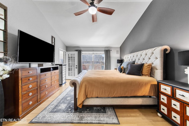 bedroom featuring light wood-style flooring and lofted ceiling