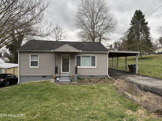 bungalow-style home featuring an attached carport, crawl space, driveway, and a front lawn