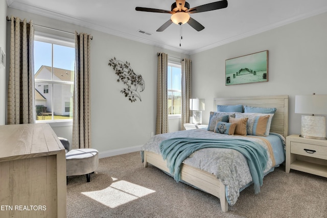 bedroom with carpet floors, multiple windows, visible vents, and crown molding