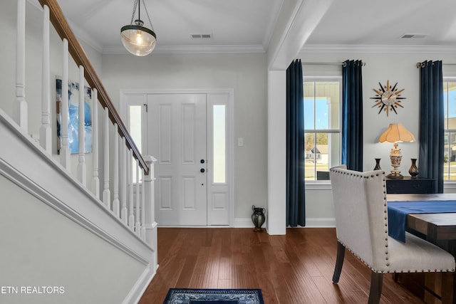 foyer entrance featuring hardwood / wood-style floors, plenty of natural light, and visible vents