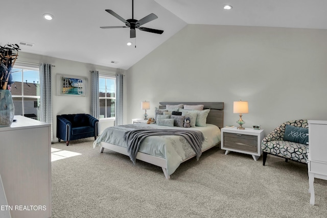 bedroom with light colored carpet, visible vents, and multiple windows