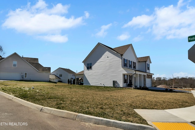 view of property exterior featuring a garage and a yard