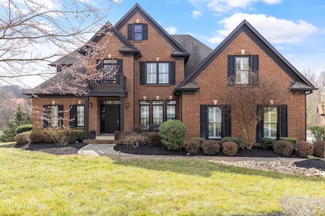 view of front of property with brick siding and a front lawn