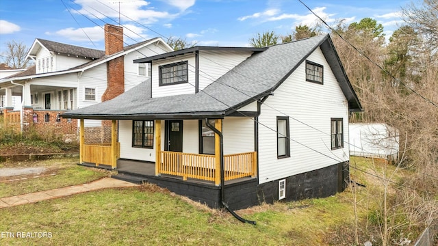 view of front of home with a porch, a front lawn, and a shingled roof