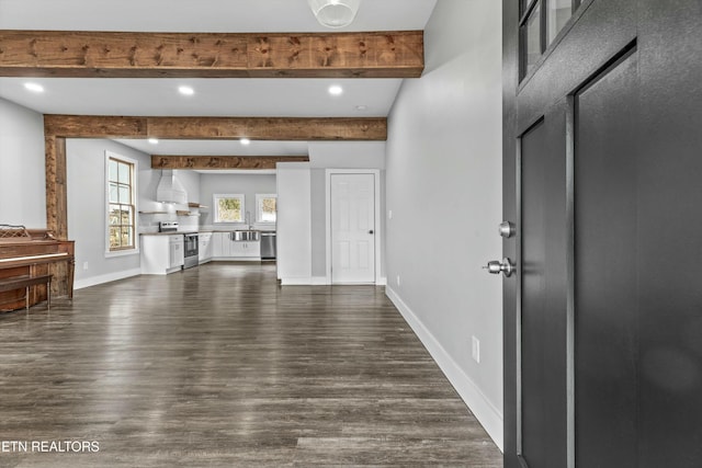 unfurnished living room with recessed lighting, beamed ceiling, baseboards, and dark wood finished floors