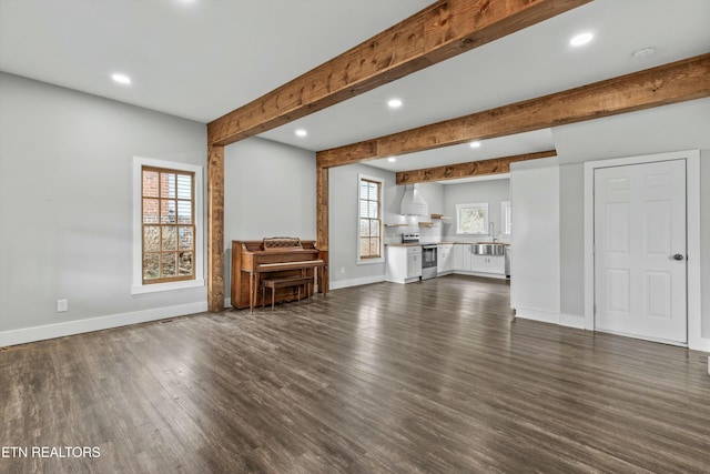 unfurnished living room featuring beam ceiling, recessed lighting, baseboards, and dark wood-style flooring