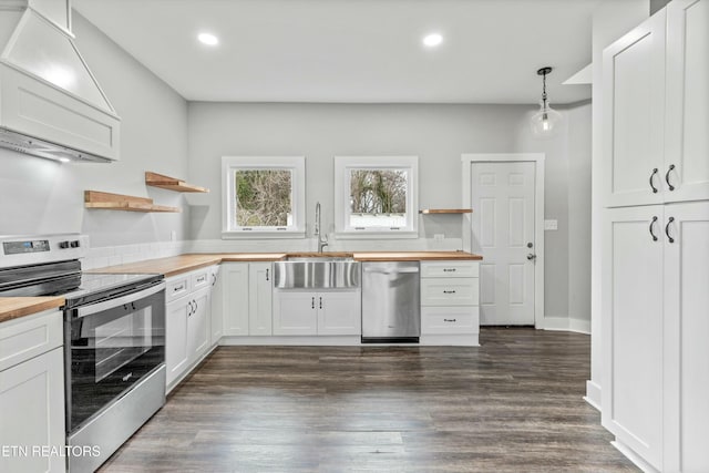 kitchen with butcher block countertops, stainless steel appliances, and open shelves