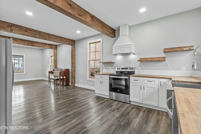 kitchen featuring dark wood finished floors, custom exhaust hood, open shelves, appliances with stainless steel finishes, and butcher block counters