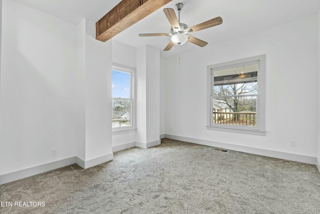 spare room featuring beam ceiling, visible vents, baseboards, and carpet