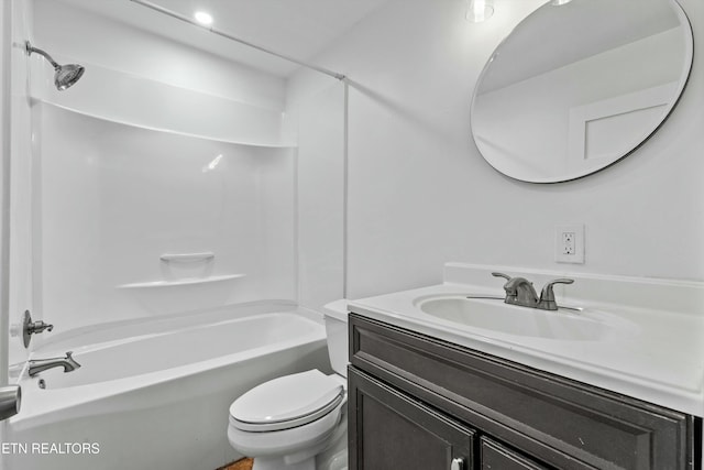 bathroom with tub / shower combination, toilet, and vanity