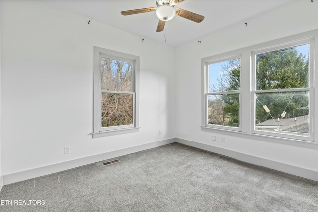 empty room featuring visible vents, baseboards, ceiling fan, and carpet flooring