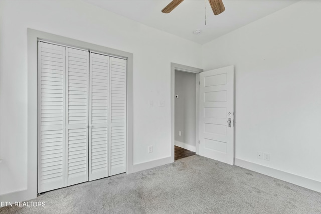 unfurnished bedroom with a closet, carpet flooring, baseboards, and ceiling fan