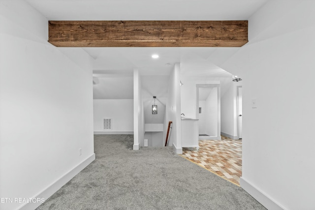 carpeted empty room with visible vents and baseboards