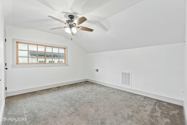 additional living space with a ceiling fan, visible vents, baseboards, lofted ceiling, and carpet flooring