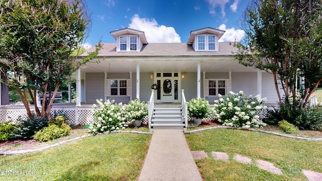 view of front of house with a porch and a front lawn