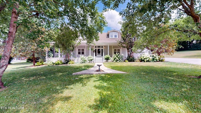 view of front of home featuring covered porch and a front lawn