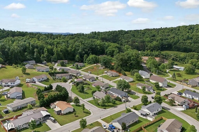 drone / aerial view with a residential view and a view of trees