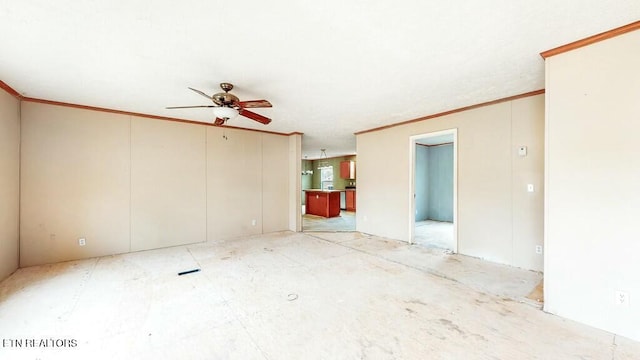 empty room featuring crown molding and ceiling fan