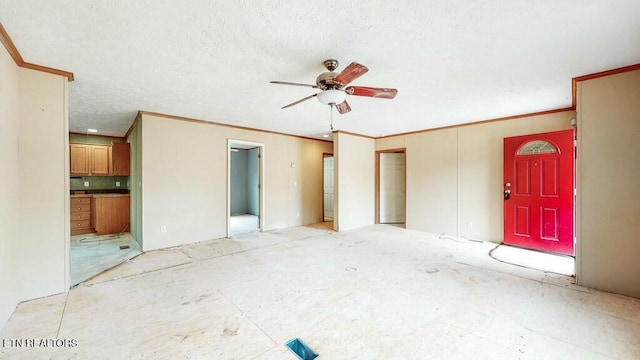 unfurnished living room featuring ornamental molding, ceiling fan, and a textured ceiling