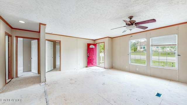 empty room with ceiling fan, ornamental molding, and a textured ceiling