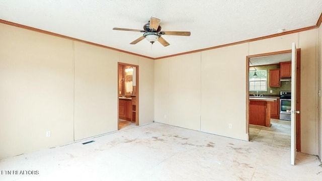 unfurnished room featuring crown molding, visible vents, a sink, a textured ceiling, and ceiling fan