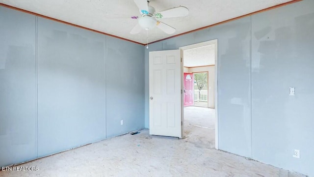 spare room featuring ceiling fan and crown molding