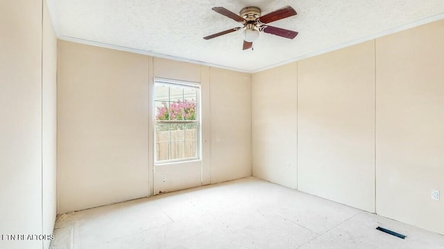 spare room with a ceiling fan, visible vents, ornamental molding, and a textured ceiling