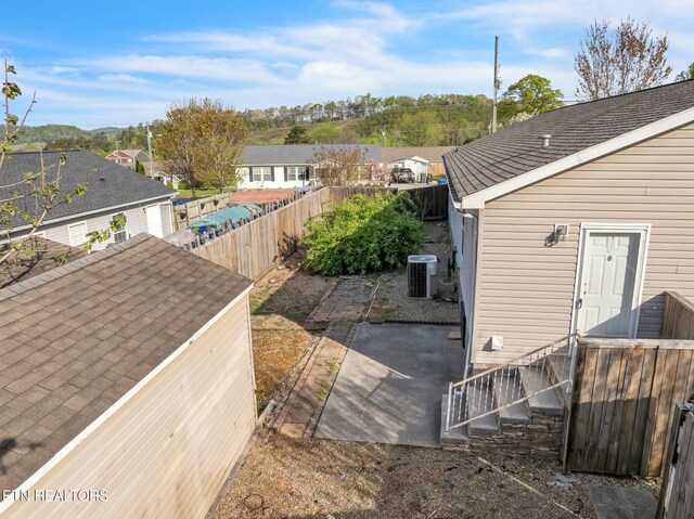 902 Oak Village Ct, Dandridge, TN 37725 - exterior space featuring central air condition unit, a patio area, a shingled roof, and a fenced backyard