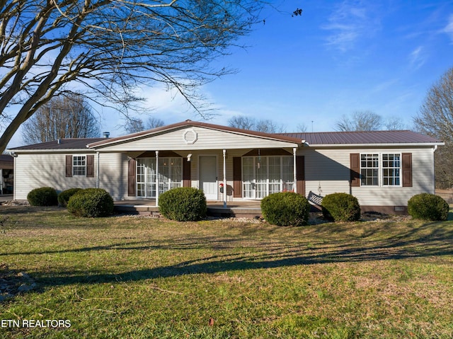 view of front of house featuring crawl space, metal roof, a porch, and a front yard