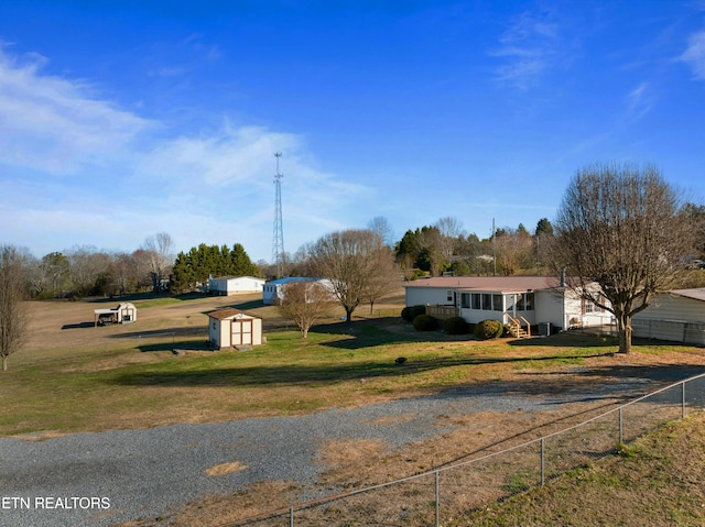 exterior space featuring an outbuilding, a shed, and fence