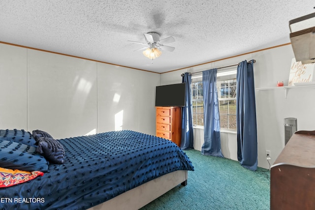 bedroom with a ceiling fan, a textured ceiling, ornamental molding, and carpet flooring