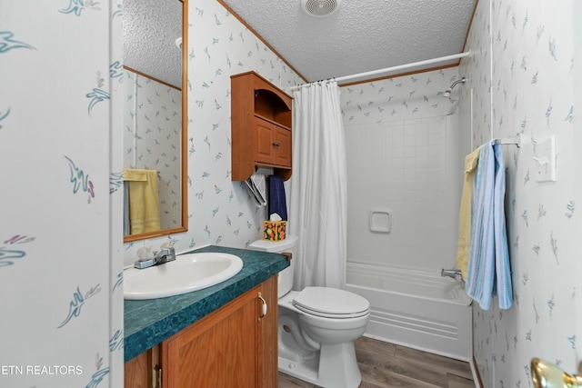 full bathroom with wallpapered walls, vanity, a textured ceiling, and wood finished floors