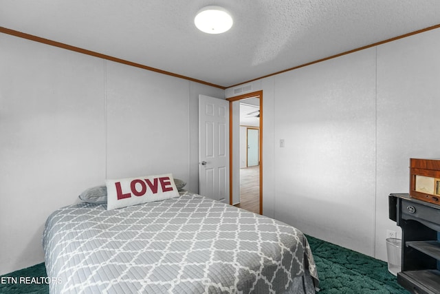 carpeted bedroom with visible vents, crown molding, and a textured ceiling