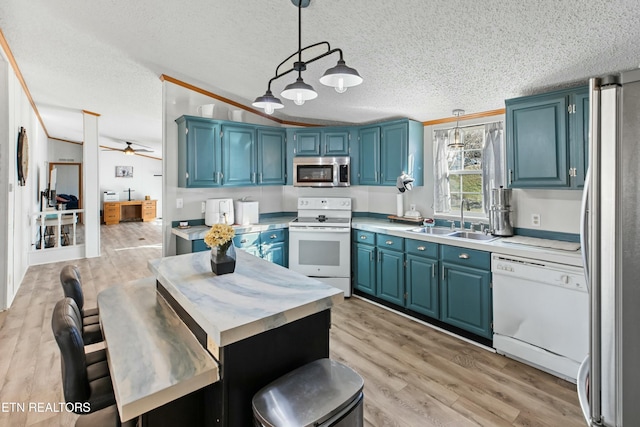 kitchen featuring blue cabinets, appliances with stainless steel finishes, and a sink