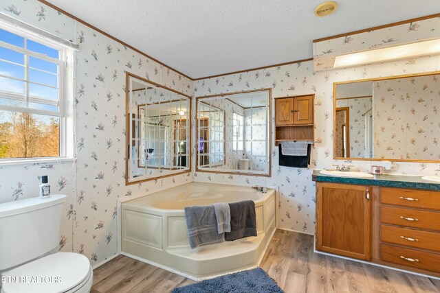 full bath featuring wood finished floors, a textured ceiling, and wallpapered walls