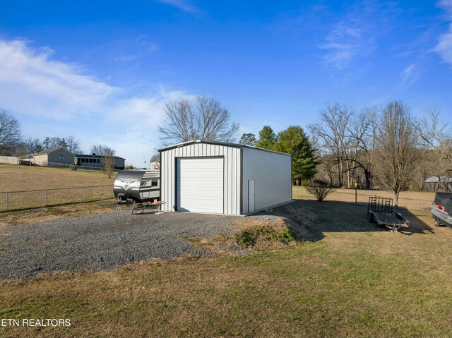 detached garage featuring fence