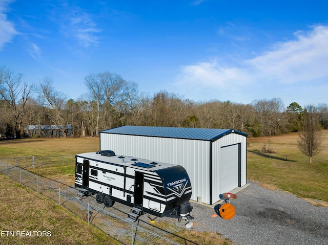 view of outbuilding with fence and an outbuilding