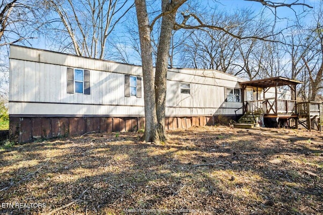 view of side of home with a wooden deck