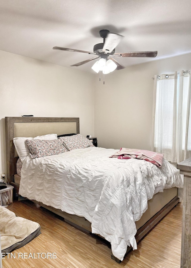bedroom with ceiling fan and wood finished floors