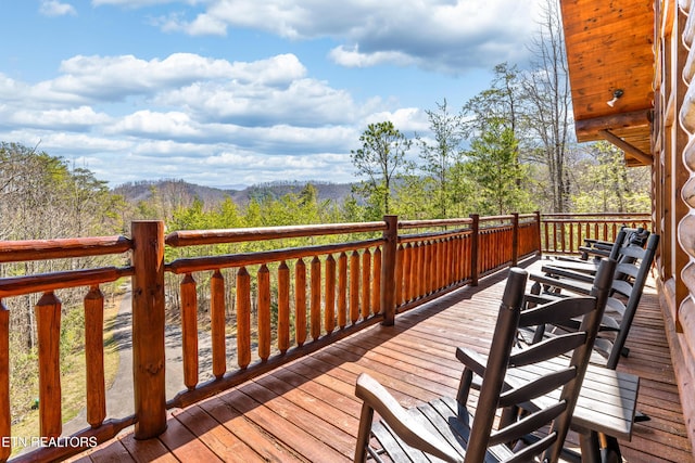 wooden terrace with a view of trees