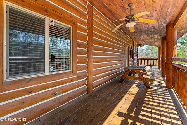 wooden deck featuring covered porch and a ceiling fan