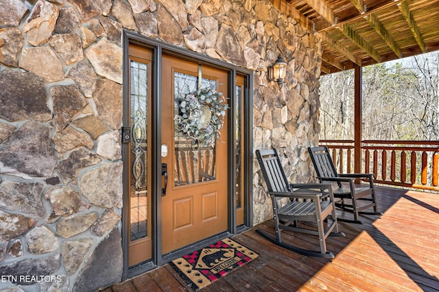 doorway to property with stone siding