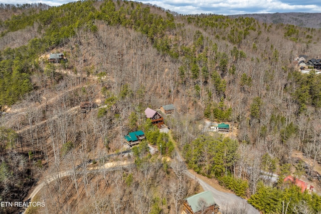 birds eye view of property featuring a wooded view