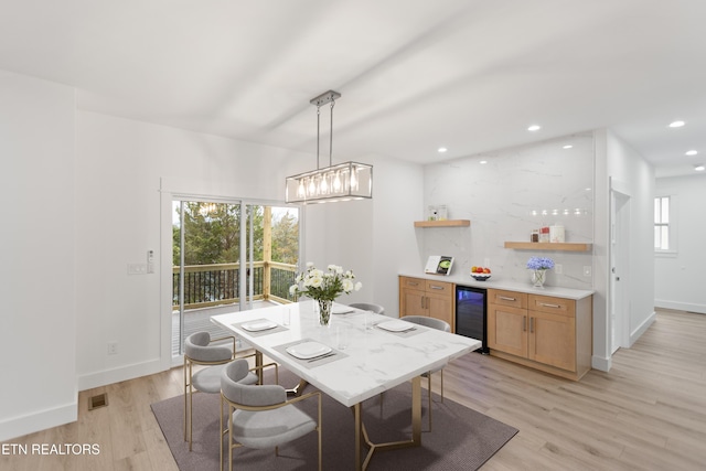 dining space featuring beverage cooler, visible vents, recessed lighting, and light wood-type flooring