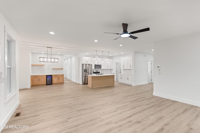 unfurnished living room with visible vents, light wood-style flooring, recessed lighting, baseboards, and ceiling fan