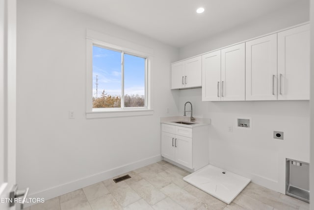 laundry room featuring electric dryer hookup, visible vents, a sink, cabinet space, and hookup for a washing machine