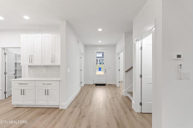 interior space with stairway, recessed lighting, light wood-style floors, and baseboards