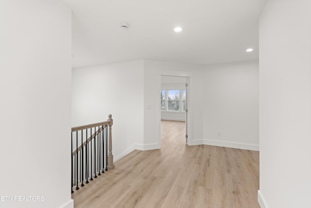 empty room with recessed lighting, baseboards, and light wood finished floors